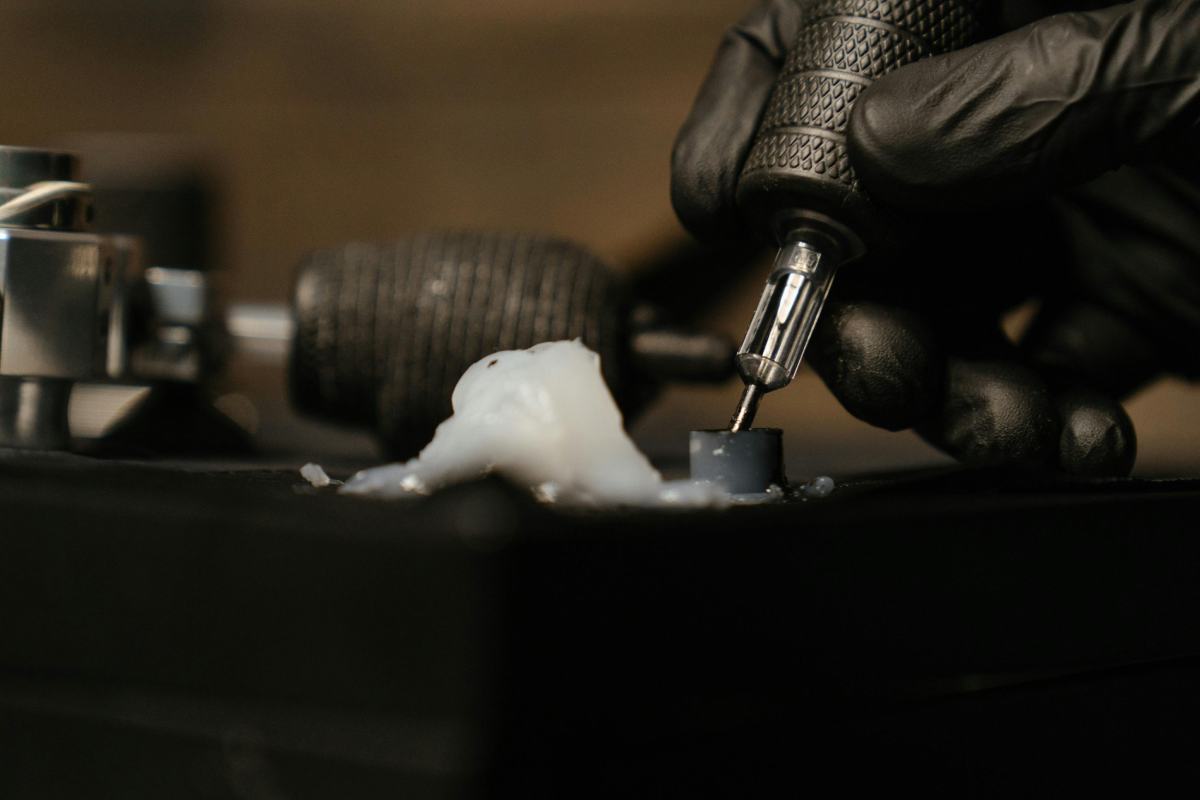 A tattoo artist's hand getting ink.