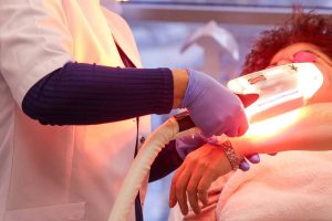 Woman getting laser hair removal treatment