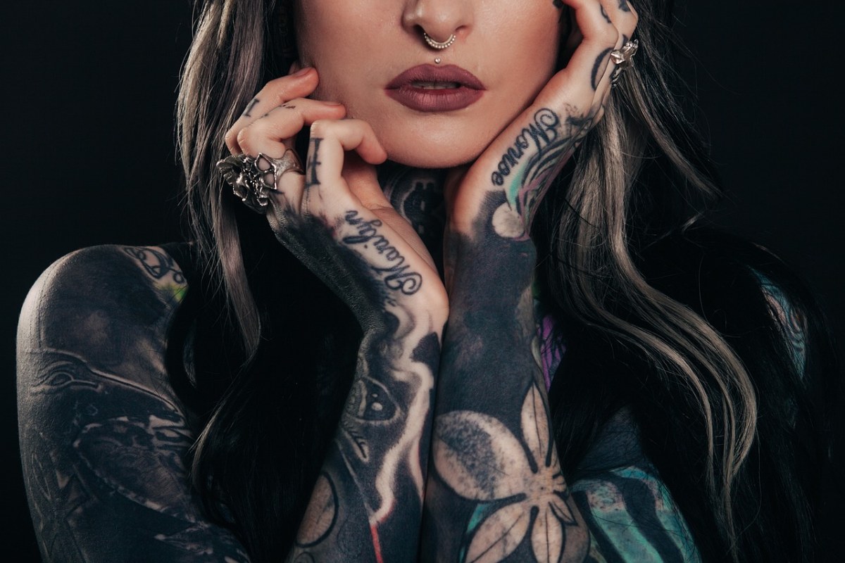 A girl with cover up tattoos on her arms