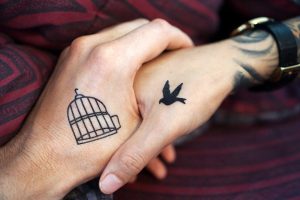 Bird and a cage tattoo