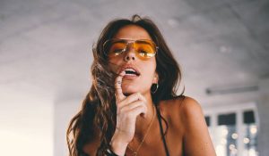 Finger tattoo woman biting lips