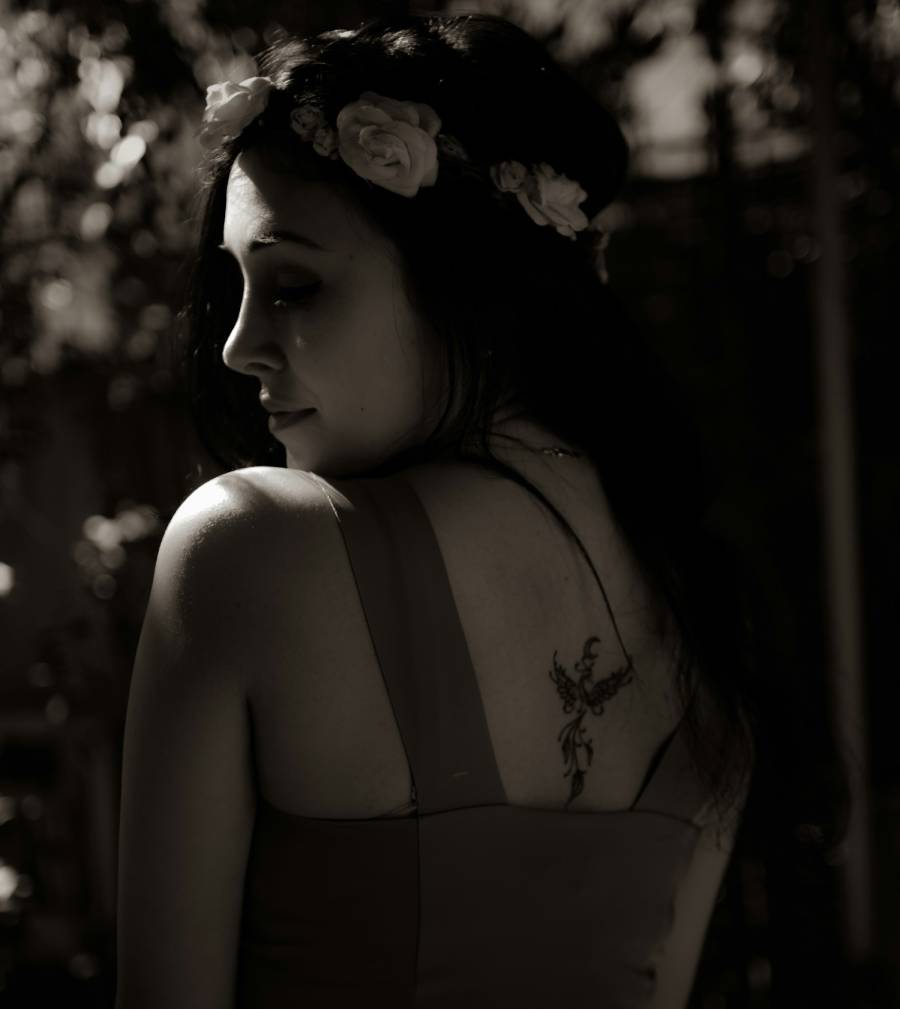Woman with a phoenix back tattoo