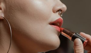 Ear and Nose piercing, woman putting makeup, lipbalm