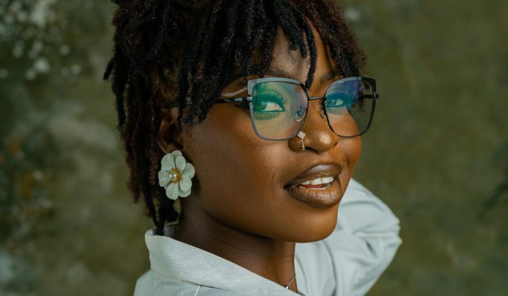 Stylish Young Woman with Glasses and Earrings wearing fake nose piericng